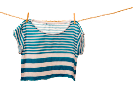 blue tshirt hanging on a rope clothesline isolated on whiteの写真素材