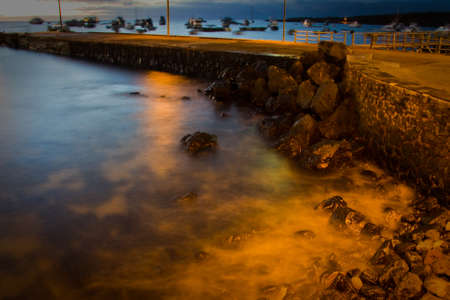 View of pier in San Cristobal island, Galapagos, during sunset, Ecuadorの写真素材
