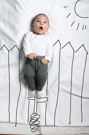 Cute infant baby boy on pogo stick sketchの写真素材