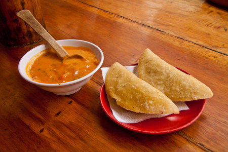 Two delicious morocho empanadas served with chilli sauceの写真素材