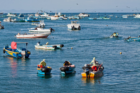 MANABI, ECUADOR - JUNE 5, 2012: Busy fishermen in the morning along a beach shore, Puerto Lopez.のeditorial素材