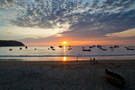 Beautiful sunset view of Salango island surrounded by fishing boats in Manabi, Ecuadorの写真素材