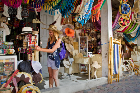 MANABI, ECUADOR - JUNE 1, 2012: Unidentified happy female tourist in a handcraft market in Montecristi, Ecuadorのeditorial素材