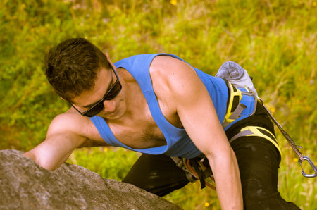 shot from above angle of man climbing mountain with sunglasses