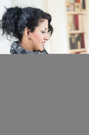 pregnant woman wearing casual clothes standing holding laptopの写真素材