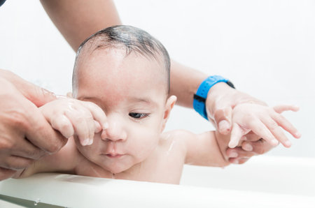 Close up portrait of sweet baby boy in the bathtub