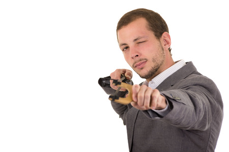 Hansome buisness man concentrated aiming a slingshot isolated over white background.の写真素材