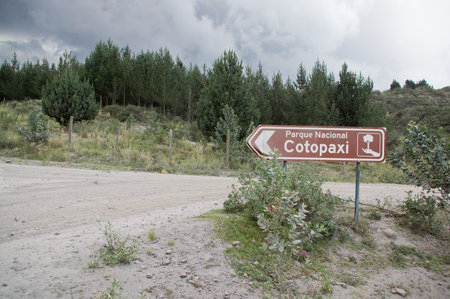 Entrance sign in Cotopaxi National Park and area covered with ashes from volcano eruption, Ecuadorの写真素材