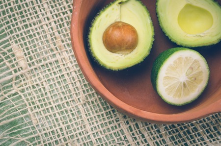 fresh ripe avocados and lime in bowl.の写真素材