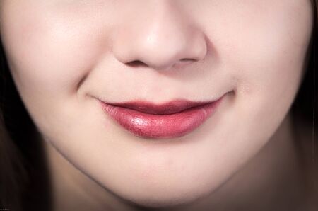 Closeup of pretty young girl's mouth smilingの写真素材