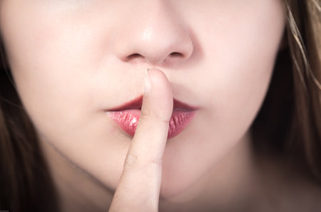 Closeup of pretty young girl's mouth expressing silence