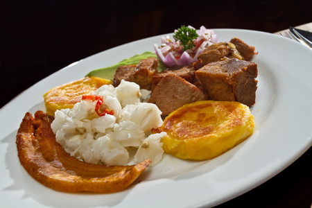 Fritada, fried pork served with potato tortillas, typical ecuadorian foodの写真素材
