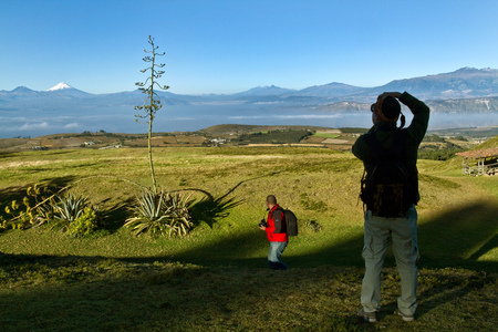 IMBABURA, ECUADOR - JUNE 29, 2011: Unknown tourist taking a photo of Cotopaxi volcano in the andean highlands.のeditorial素材