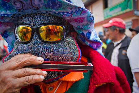 PICHINCHA, ECUADOR - JUNE 30, 2011: Unidentified musician playing harmonica at Inti Raymi indigenous celebration in Cayambe, Ecuadorのeditorial素材