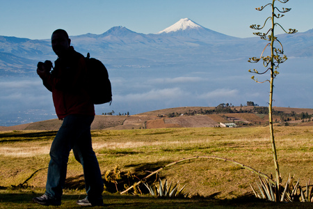 IMBABURA, ECUADOR - JUNE 29, 2011: Unknown man walking in the andean highlands with Cotopaxi volcano in the background.のeditorial素材