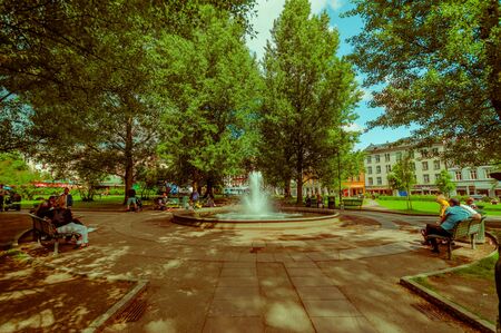 OSLO, NORWAY - 8 JULY, 2015: Inside Olaf Ryes Plass, recreational park area located at charming neighbourhood Gunerlokka with beautiful green trees, water fountain and nice blue sky.のeditorial素材