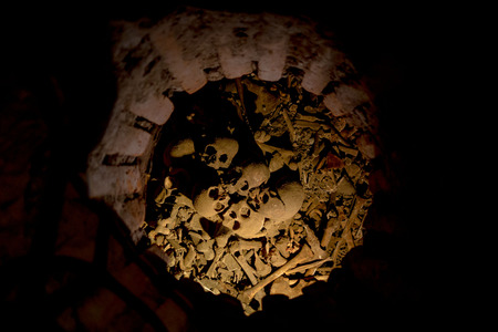 QUITO, ECUADOR- AUGUST 4, 2015: Dark hole with human bones and skulls lying in a pile, oart of San Diego church Quito.のeditorial素材
