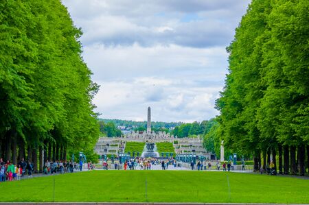 OSLO, NORWAY - 8 JULY, 2015: The famous monument Monolitten seen from distance sorrounded by other sculptures and green vegetation in Vigelandsparken.のeditorial素材