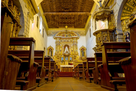 QUITO, ECUADOR- AUGUST 4, 2015: Inside San Diego church shot from the floor showing wooden benches leading up to heavily golden decorated alter.のeditorial素材