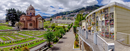 QUITO, ECUADOR- AUGUST 4, 2015: Panoramic view of San Diego church cemetary in Quito showing tomb graves and gravestones with nice green garden including famous mountain Panecillo background.のeditorial素材