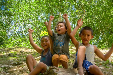 CAHAL PECH, BELIZE - APRIL 9, 2014: Closeup portrait of three cheerful unknown local boys  in Cahal Pechのeditorial素材
