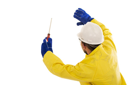 man with screwdriver in yellow rain protective suit