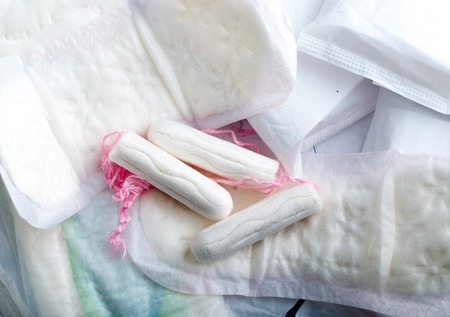 Sanitary pads for women with clean white tampons lying on top.の写真素材