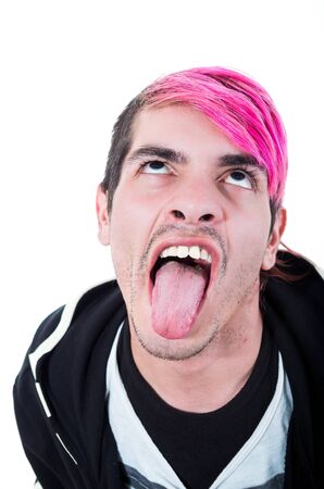 Headshot hispanic young adult with pink hair and black hoodie sweater posing for camera making facial expressions.の写真素材