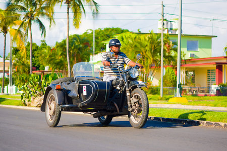 CIENFUEGOS, CUBA - SEPTEMBER 12, 2015: Classic motorcycle with sidecar are still in use and old timers have become an iconic viewのeditorial素材