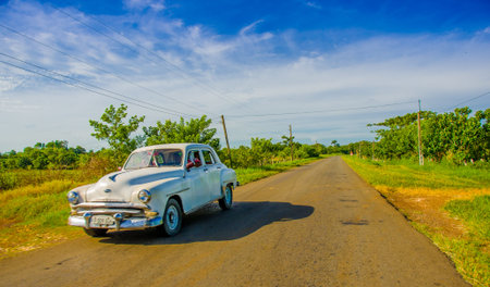CENTRAL ROAD, CUBA - SEPTEMBER 06, 2015: American Oldtimer in the rural road system used for transportationのeditorial素材