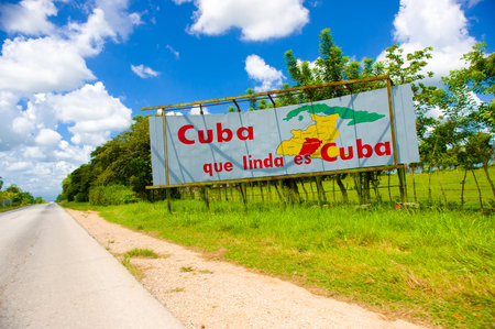 CENTRAL ROAD, CUBA - SEPTEMBER 06, 2015: Communist propaganda billboard in the rural highway system
