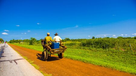 CENTRAL ROAD, CUBA - SEPTEMBER 06, 2015: Horse and a cart on a road in rural, Cuba.のeditorial素材