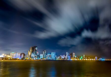 Beautiful long exposure shot of Cartagena cityscape with the ocean at night, Colombiaの写真素材