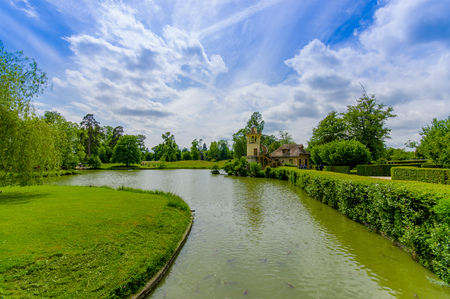 Beautiful lake view in the Hameau de la Reine, The Queen's Hamlet is a rustic retreat in Versailles, Paris, Franceの写真素材