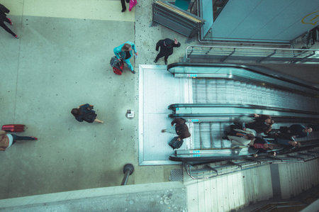 PARIS, FRANCE - JUNE 1, 2015: Passengers in the electric escalators in the Gare du Nord station in...