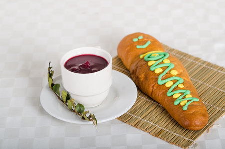Traditional bread babies or guaguas de pan and colada morada drink, served on the Day of the Dead in...