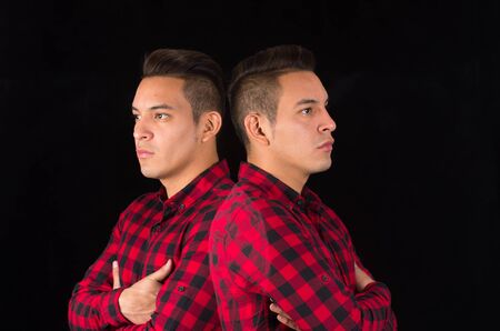 Hispanic male wearing red black squared shirt from profile angle, reflecive effect used for an artistic presentation.の写真素材