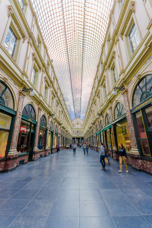 BRUSSELS, BELGIUM - 11 AUGUST, 2015: Galerie Royales Saint Hubert, very nice view down shopping alley showing spectacular glass roof construction and several shops along both sides.のeditorial素材