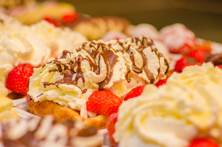 BRUSSELS, BELGIUM - 11 AUGUST, 2015: Famous belgian waffles as displayed in store with cream, berries and chocolate sauce.のeditorial素材