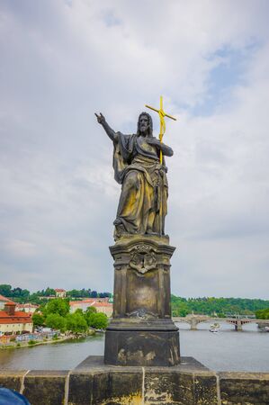 Prague, Czech Republic - 13 August, 2015: Famous Charles Bridge and one of its many famous statues placed alongside it.のeditorial素材
