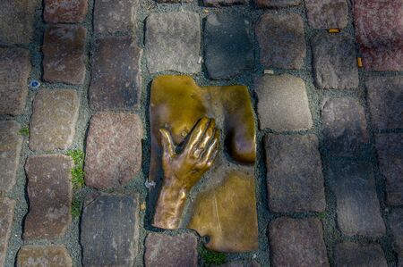 Amsterdam, Netherlands - July 10, 2015: Bronze hand holding womans breast, one of many mysterious statues found around the city.のeditorial素材