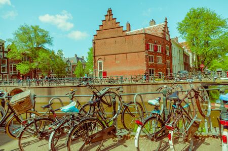 Amsterdam, Netherlands - July 10, 2015: Bicycle parking alongside one of the many water channels running through city.のeditorial素材