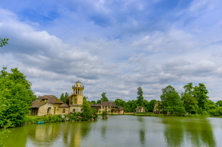 Paris, France - June 1, 2015: The Queens Hamlet, Versailles, built as a leisure retreat for her majesty and closest friends, beautiful rustic architecture with lakes, garden environment.のeditorial素材