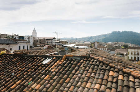 Beautifull view from a roof in Quito city, cloudy day in historical center, hill in the backの写真素材