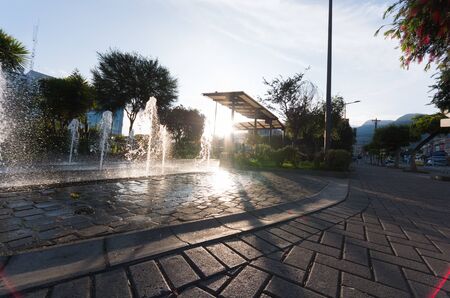Modern and beutifull waterfall with sun in the back. Water drops dancing in a big splashの写真素材