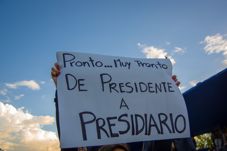 Quito, Ecuador - April 7, 2016: Group of people Holding protest signs, police and journalists during anti government protests in Shyris Avenue.のeditorial素材