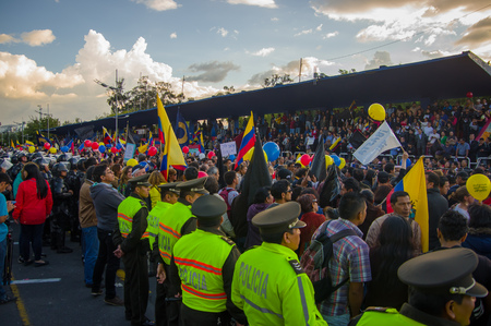Quito, Ecuador - April 7, 2016: Police awaiting overlooking peaceful anti government protests in Shyris Avenue, beautiful blue sky and buildings background.のeditorial素材