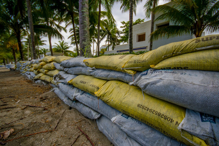 Esmeraldas, Ecuador - March 16, 2016: Sandbags to protect against the flood by tsunami in Same Beach, Casablanca.のeditorial素材