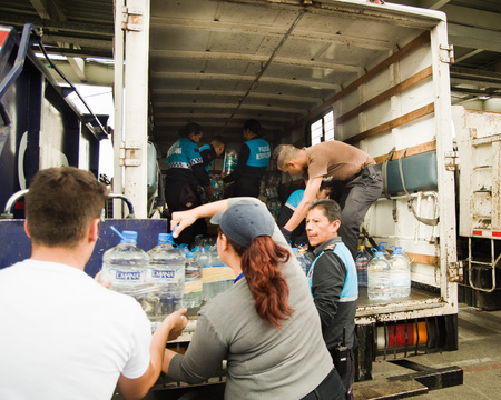 Quito, Ecuador - April 23, 2016: Unidentified citizens of Quito providing disaster relief food, clothes, medicine and water for earthquake survivors in the coast. Gathered at Bicentenario Park.のeditorial素材