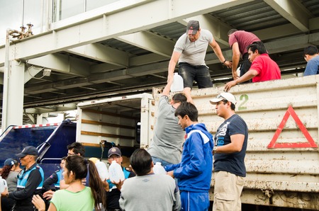 Quito, Ecuador - April 23, 2016: Unidentified citizens of Quito providing disaster relief food, clothes, medicine and water for earthquake survivors in the coast. Gathered at Bicentenario Park.のeditorial素材